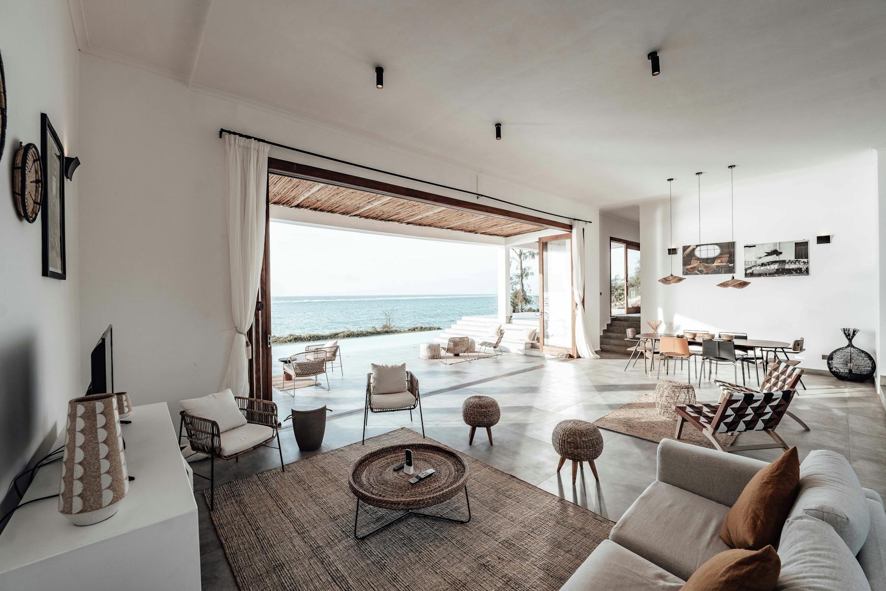 Minimalist modern living room in a Miami high-rise with floor-to-ceiling ocean view